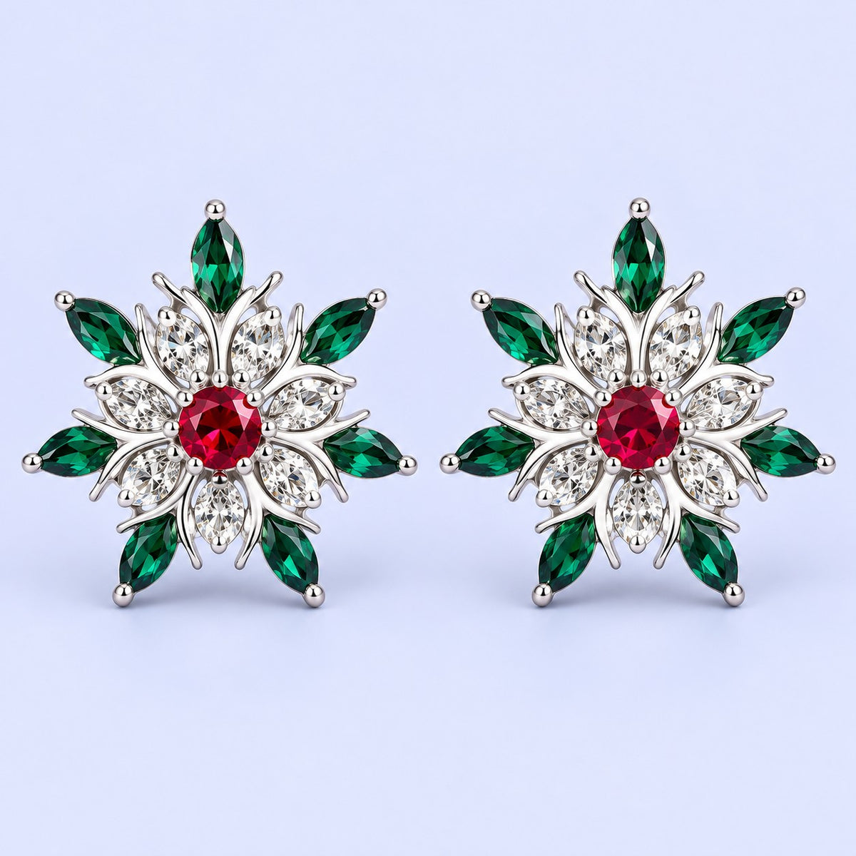 Silver snowflake stud earrings with red and green stones on a pale icy lavender backdrop.