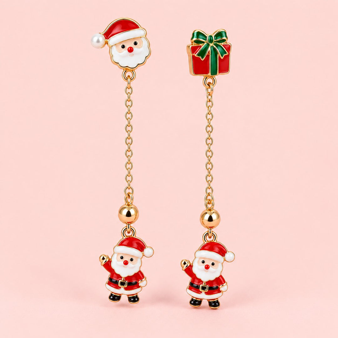 Long Santa and gift earrings with gold-tone chains on a soft blush background.