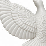 A close view shows the raised feather texture and matte finish of a white acrylic dove ornament.