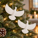 White acrylic friendship dove ornaments add a peaceful finishing touch to an evergreen Christmas tree.