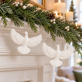 White acrylic friendship dove ornaments hang from a simple holiday mantel garland in a living room.
