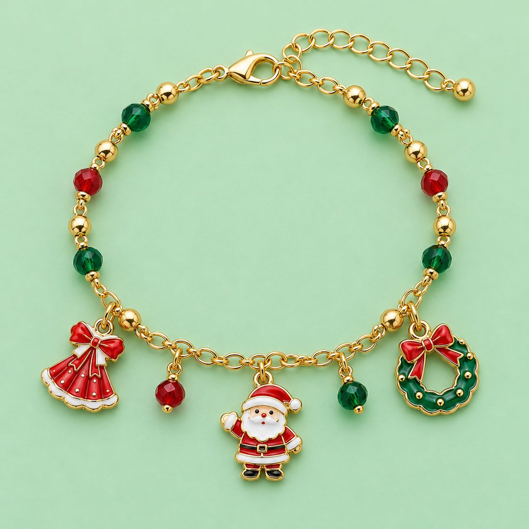 Gold Christmas charm bracelet with Santa, wreath, red dress charm and colored beads on a mint studio backdrop.