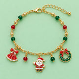 Gold Christmas charm bracelet with Santa, wreath, red dress charm and colored beads on a mint studio backdrop.