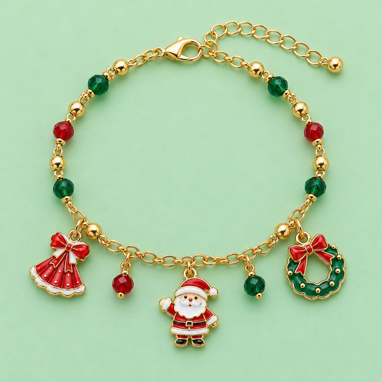 Gold Christmas charm bracelet with Santa, wreath, red dress charm and colored beads on a mint studio backdrop.