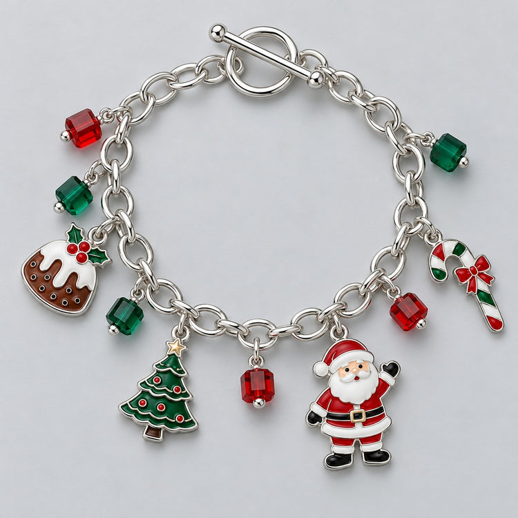 Silver-tone Christmas charm bracelet with toggle clasp, Santa, tree, candy cane and red-green beads on pale grey.