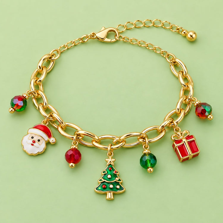 Gold Christmas charm bracelet with Santa, gift, tree and colorful beads arranged on a light green studio backdrop.