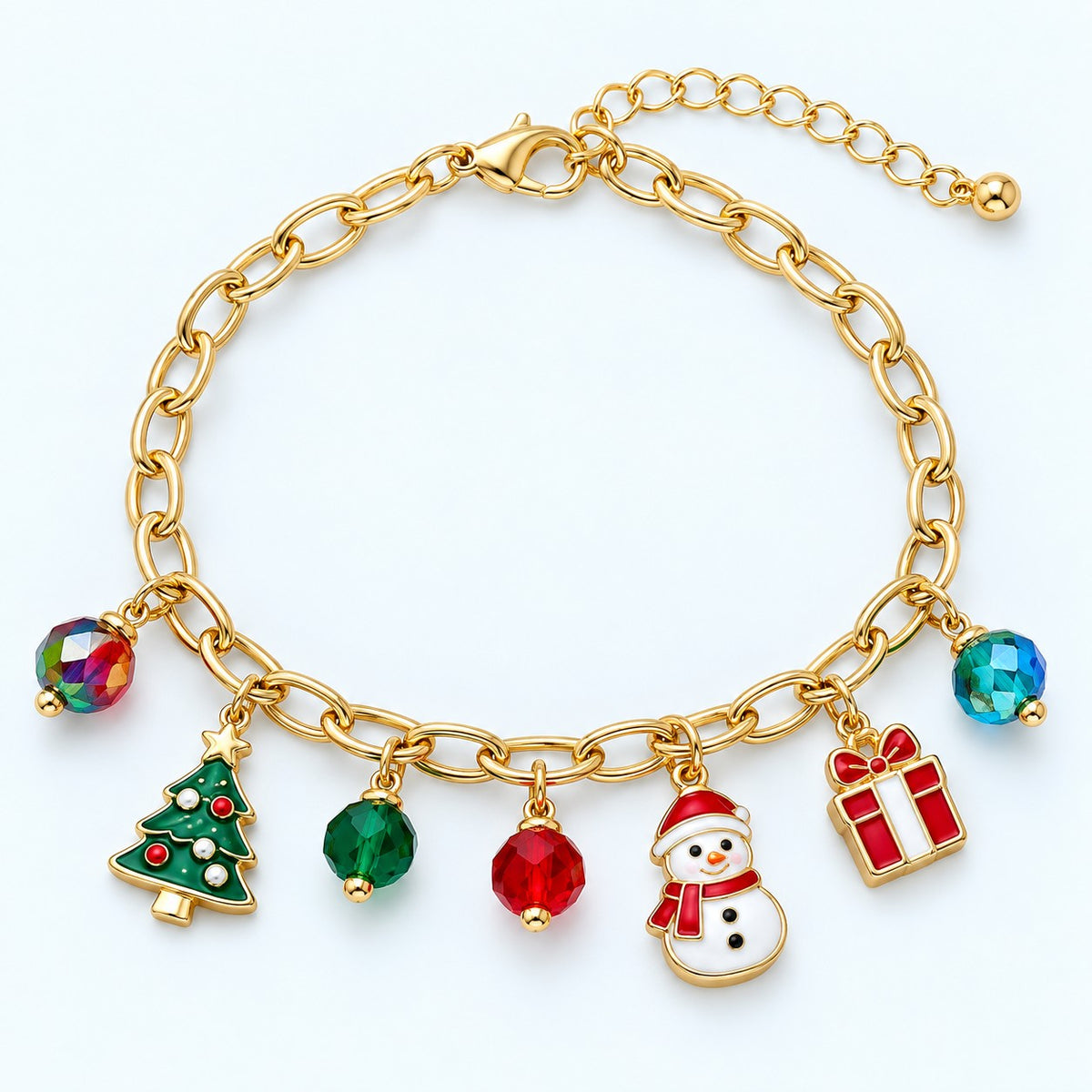 Gold Christmas charm bracelet with snowman, tree, gift and colored beads on a light blue-white studio backdrop.