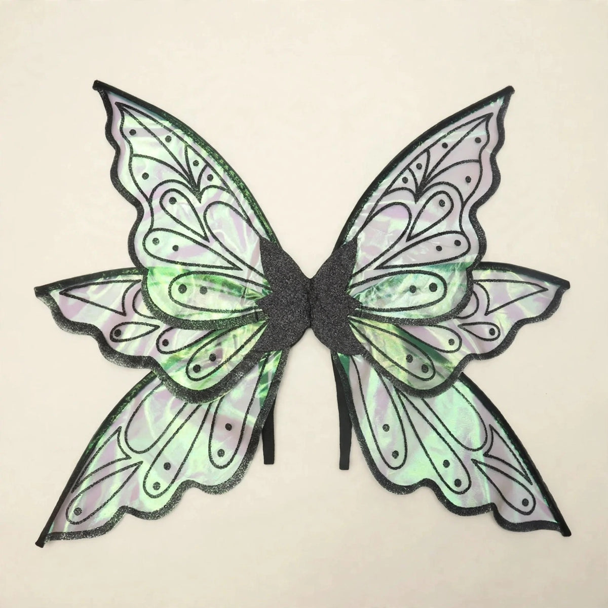 Iridescent fairy wings with black borders, dotted teardrop patterns, and pale green reflections rest against a cream background.