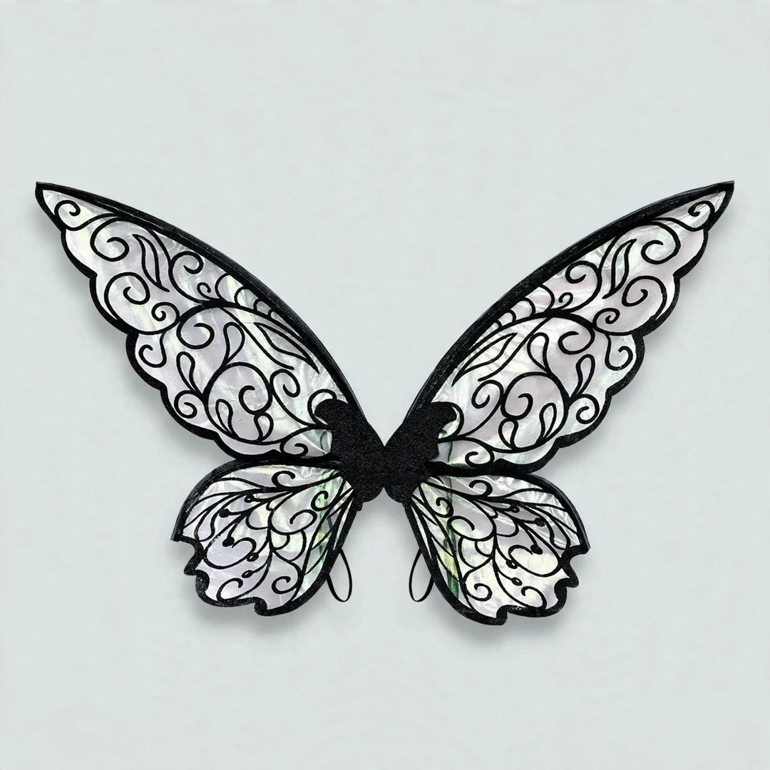 Fairy wings with black swirling outlines, translucent iridescent panels, and rounded lower sections rest against a light grey background.