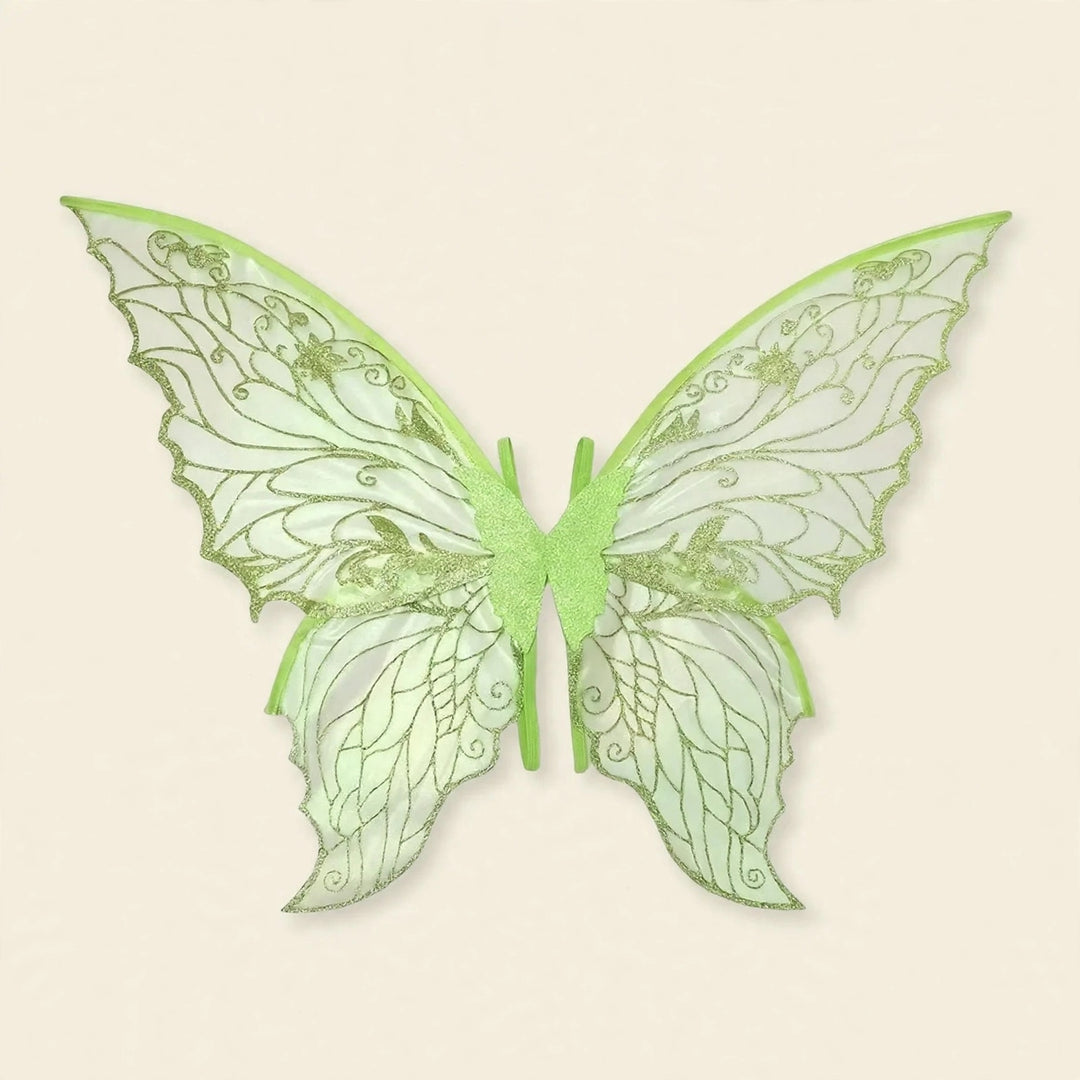 Pale green fairy wings feature translucent panels, glittery swirling patterns, scalloped edges, and central straps against a cream background.