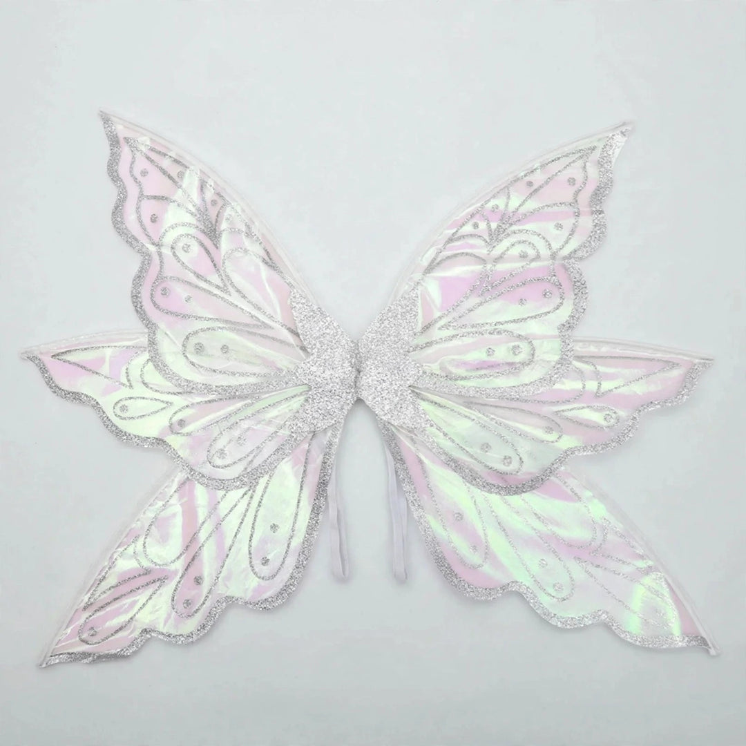 Iridescent fairy wings feature silver glitter borders, swirling patterns, and pink and green reflections against a pale gray background.