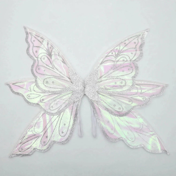 Iridescent fairy wings feature silver glitter borders, swirling patterns, and pink and green reflections against a pale gray background.