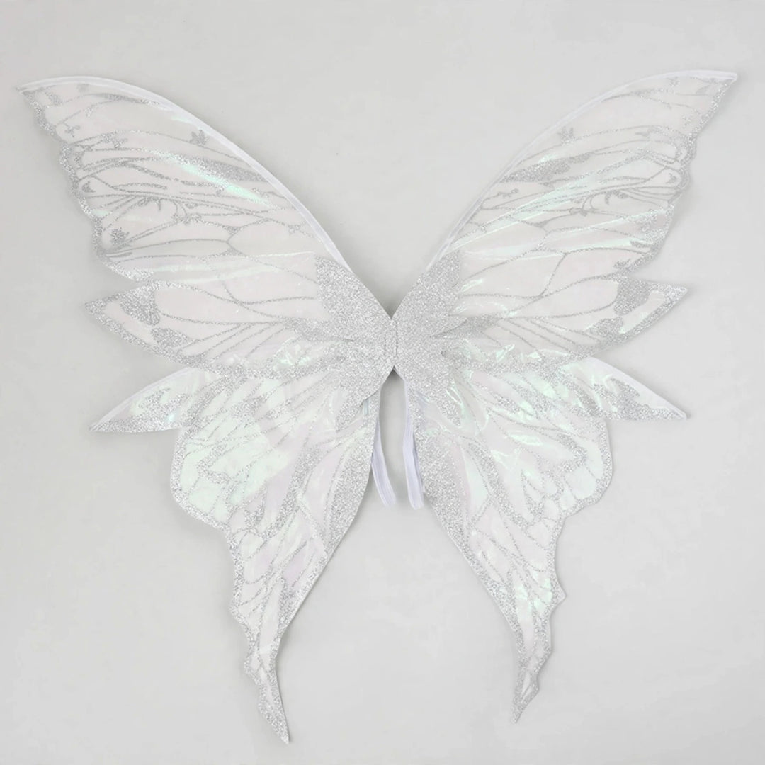 White iridescent fairy wings with glittery vein patterns and long curved lower tips spread against a light grey background.