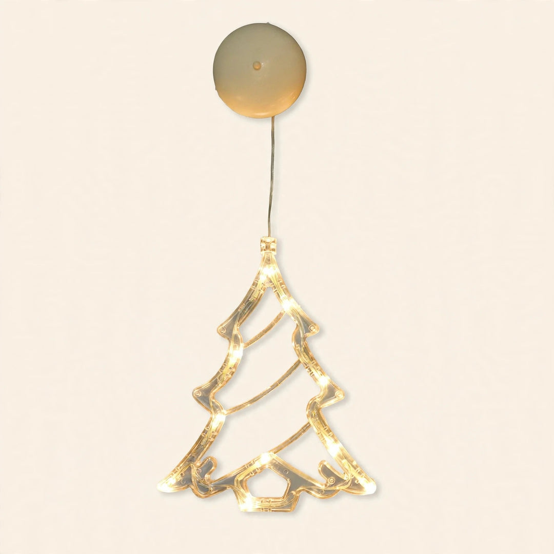 A clear Christmas tree-shaped lighted ornament glows warm white beneath a round cream housing against an off-white background.