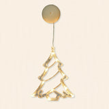 A clear Christmas tree-shaped lighted ornament glows warm white beneath a round cream housing against an off-white background.