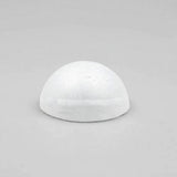 A white foam half ball sits centered on a light gray surface with ample empty space around it.