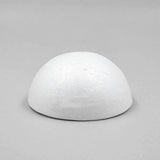 A white foam half ball with a textured curved surface rests on its flat base against a light gray background.