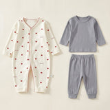 Cream heart-print baby romper lies beside a plain gray long-sleeve top and matching cuffed pants on a cream background.