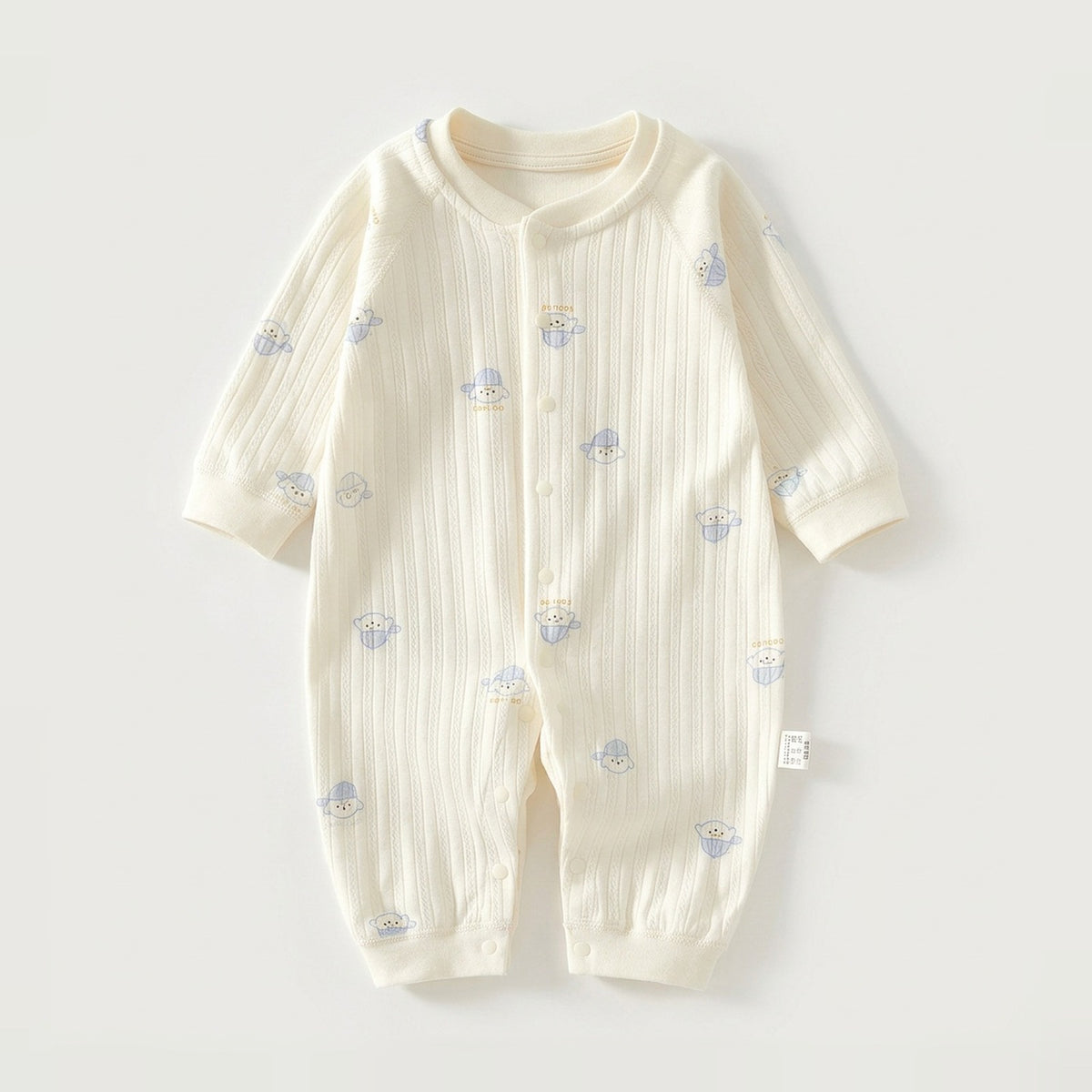 A cream-colored long-sleeve baby romper with a vertical ribbed texture and small blue cartoon bear prints, laid flat on a light gray background.