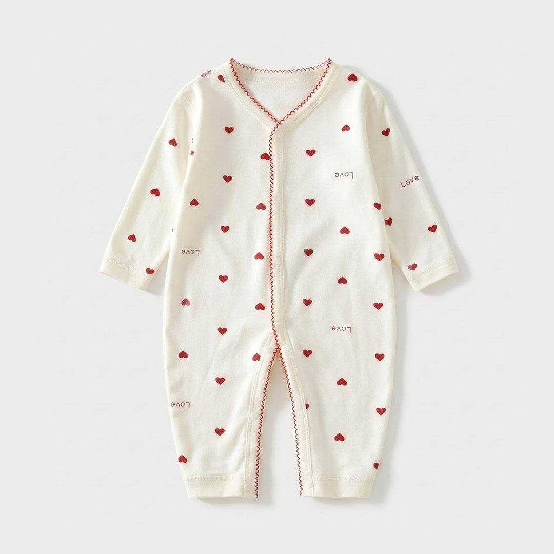 An off-white long-sleeve baby romper with a front zipper, decorated with small red hearts and the word 'Love' printed in red on the front, set against a light gray background.
