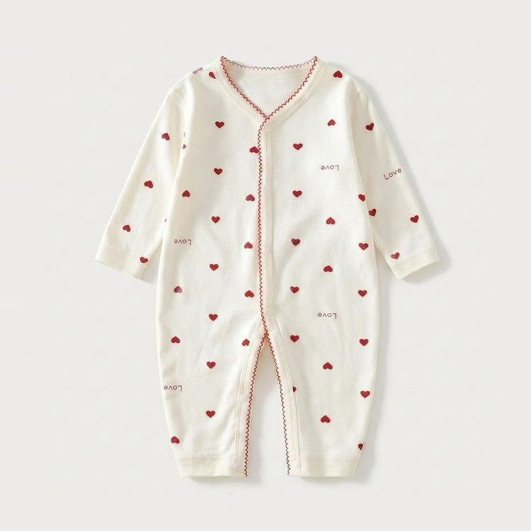 An off-white long-sleeve baby romper with a front zipper, decorated with small red hearts and the word 'Love' printed in red on the front, set against a light gray background.