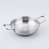 A silver stainless steel paella pan with riveted side handles is shown close up against a light gray background.