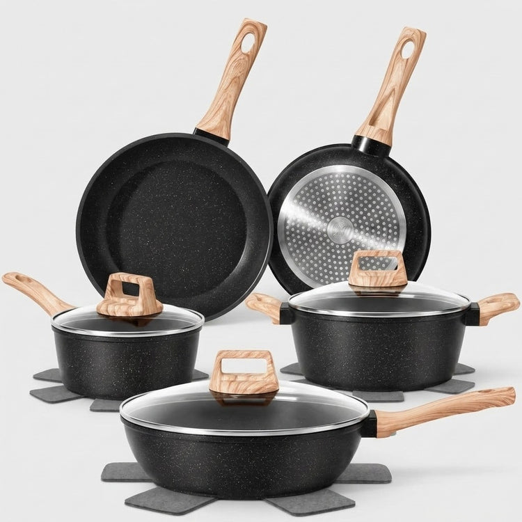 A 5-piece non-stick cookware set in black with light wood handles and lids, displayed on gray trivets against a light gray background.