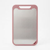 A rectangular magnetic cutting board with a brushed stainless steel center and a dusty rose pink frame, shown on a clean white background.