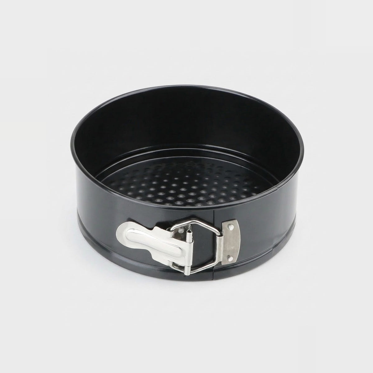 A black non-stick springform pan with a silver metal clasp and white release lever, shown on a light gray background.