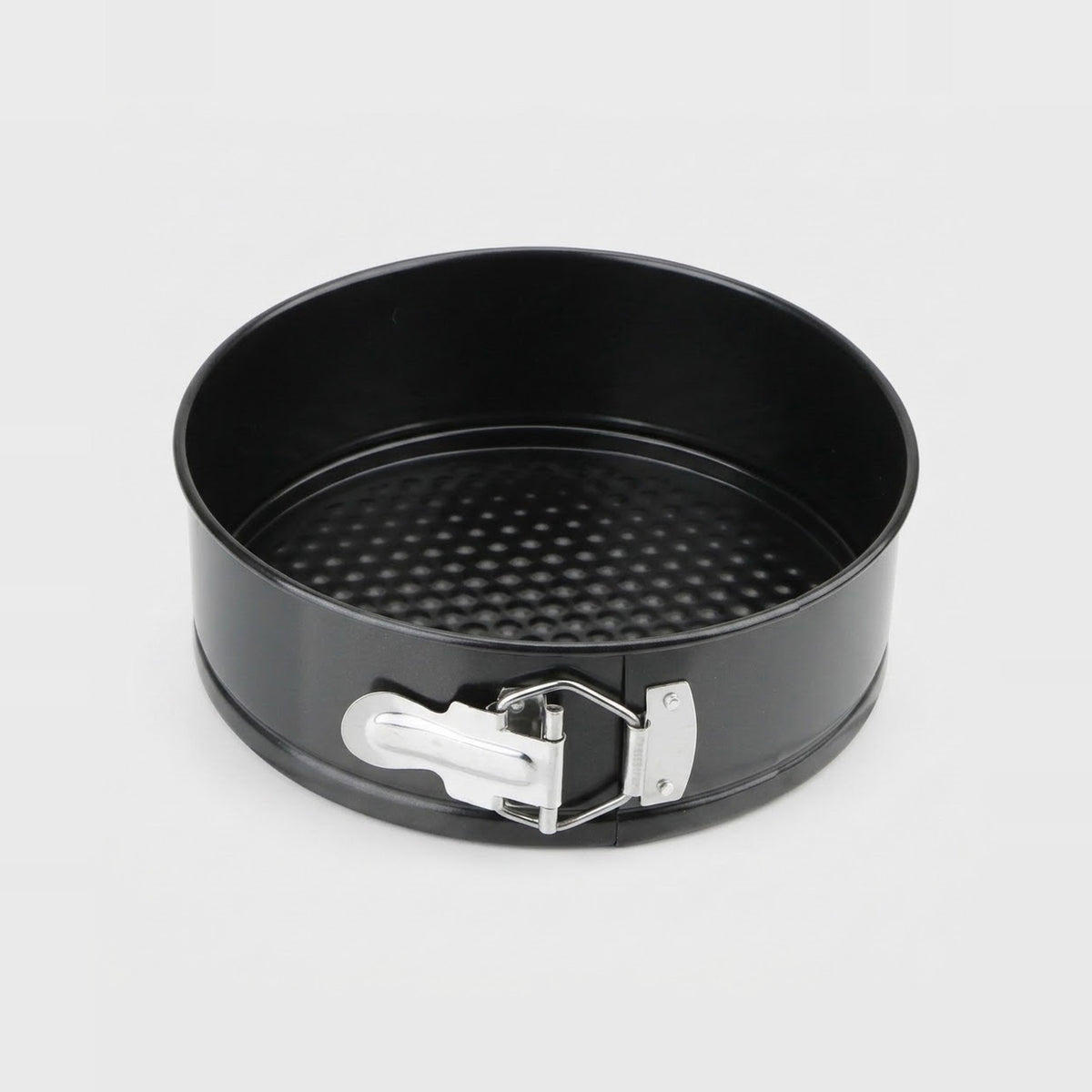 A black springform pan with a silver metal release clasp, shown from a top-down angle on a light gray background.