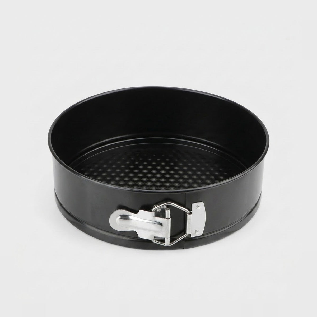 A black springform cake pan with a silver metal clasp, shown from a top-down angle on a light gray background.