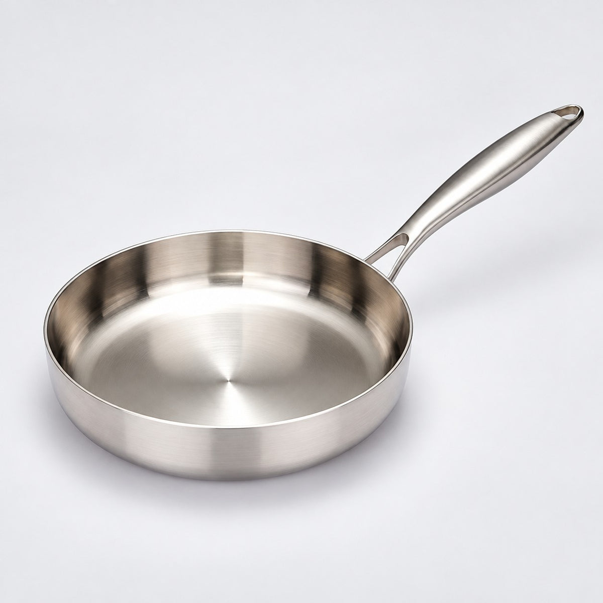 316 stainless steel frying pan, 24 cm size, centered on a light studio background with its handle visible.