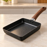 Japanese omelet pan with a speckled nonstick surface sits ready on a bright kitchen counter.