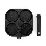 A black non-stick four-cup pan with a textured speckled finish, shown alongside its matching black handle on a plain white background.
