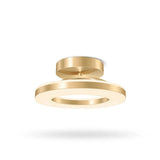 A modern semi-flush mount ceiling light fixture in a brushed gold finish, featuring concentric circular rings, shown against a plain white background with a soft shadow underneath.