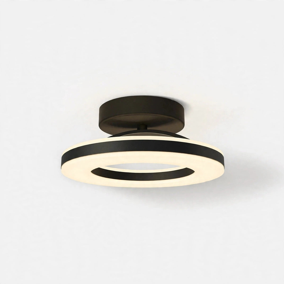 Modern semi-flush mount ceiling light with a matte black circular ceiling mount and a double-ring LED light fixture in black and warm white.