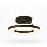 A modern semi-flush mount ceiling light fixture with a matte black metal frame and a glowing warm white LED ring, shown against a plain white background.