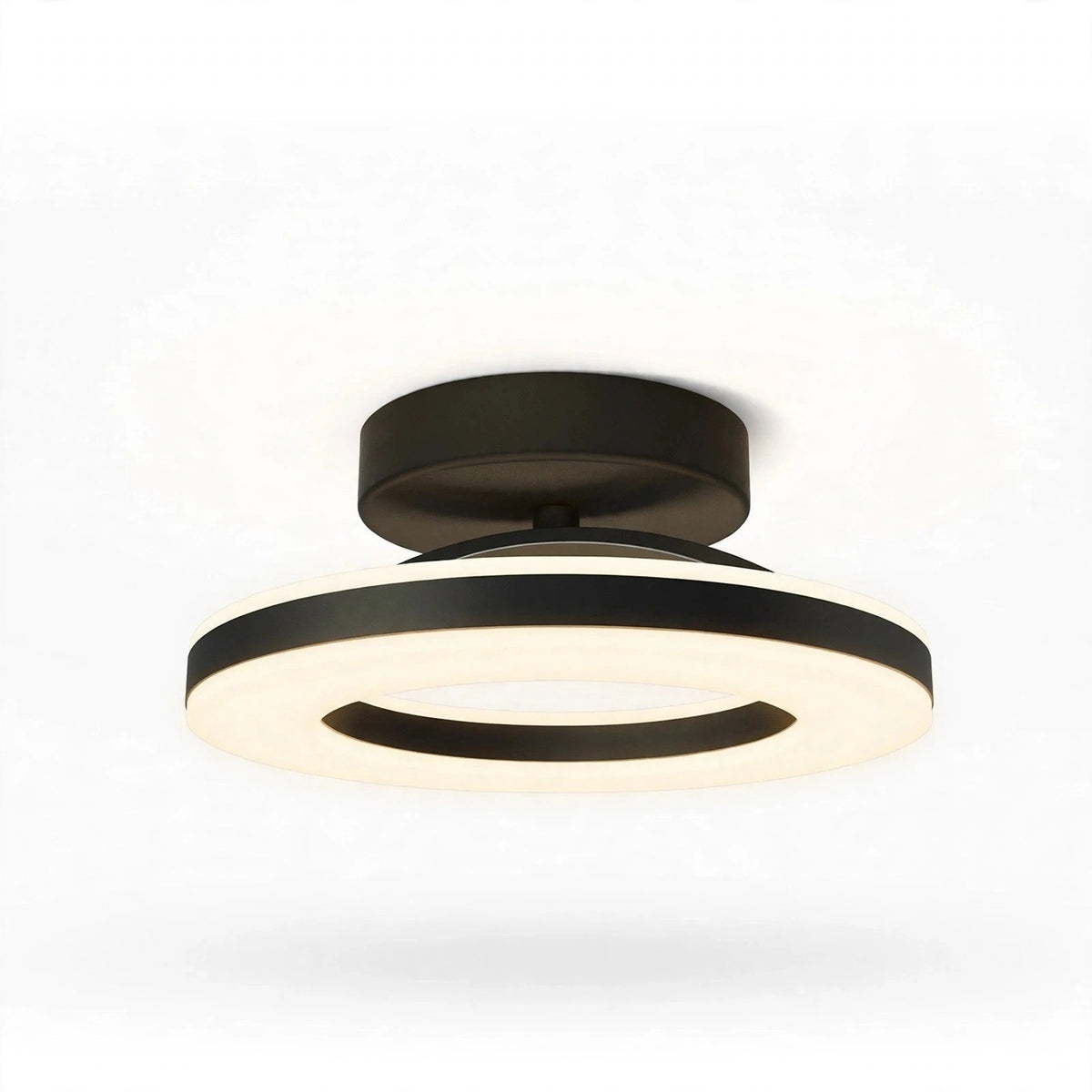 A modern semi-flush mount ceiling light fixture with a matte black metal frame and a glowing warm white LED ring, shown against a plain white background.