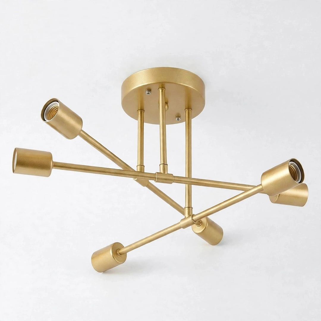 A gold-toned chandelier with crossing arms, six empty sockets, and a round ceiling canopy stands against a white background.