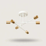 White and gold iron sputnik chandelier with six gold cylindrical sockets on crossing white arms against a plain background.