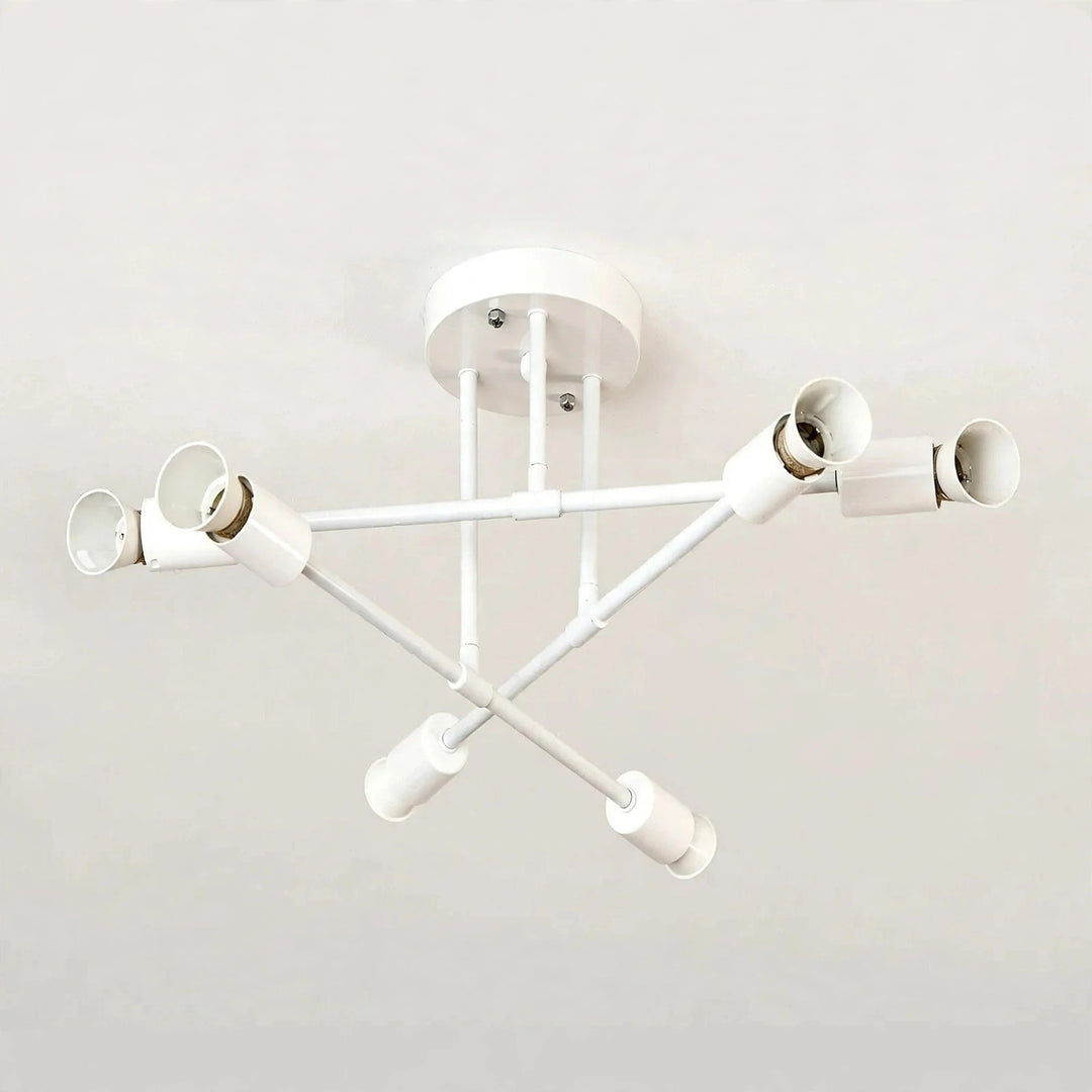White iron sputnik chandelier with six sockets on crossing arms, mounted on a plain white ceiling.