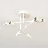 White iron sputnik chandelier with six sockets on crossing arms, mounted on a plain white ceiling.