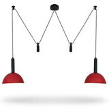 A modern two-light pendant ceiling fixture with red dome-shaped shades and black suspension rods, shown against a plain white background.