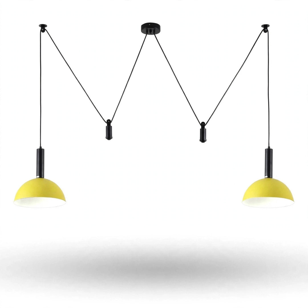 A modern two-light pendant ceiling fixture with black cords and canopies and bright yellow dome-shaped shades, shown against a plain white background.