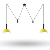 A modern two-light pendant ceiling fixture with black cords and canopies and bright yellow dome-shaped shades, shown against a plain white background.