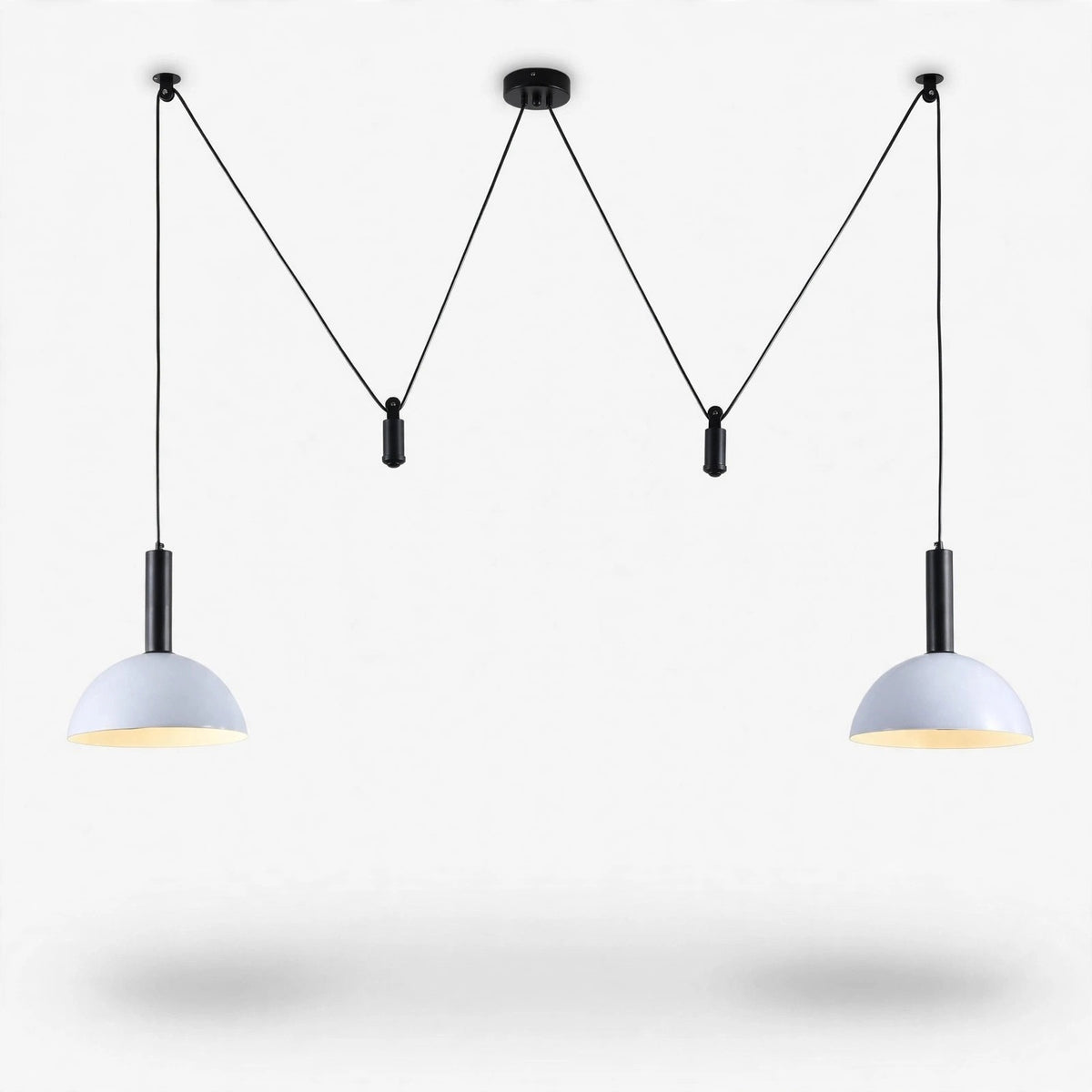 A modern two-light pendant chandelier with black metal hardware and white dome-shaped shades, suspended against a clean white background.