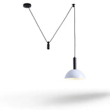 A modern pendant light with a white dome-shaped shade and black cord suspension hardware, shown against a plain white background with a soft shadow below.