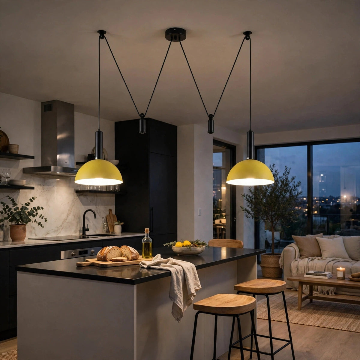 Two modern pendant lights with yellow dome shades and black cords hanging over a kitchen island in a contemporary apartment interior.