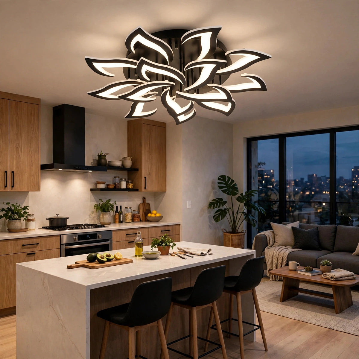 A black ceiling light with glowing white petals sits above an island in an open kitchen and living room.