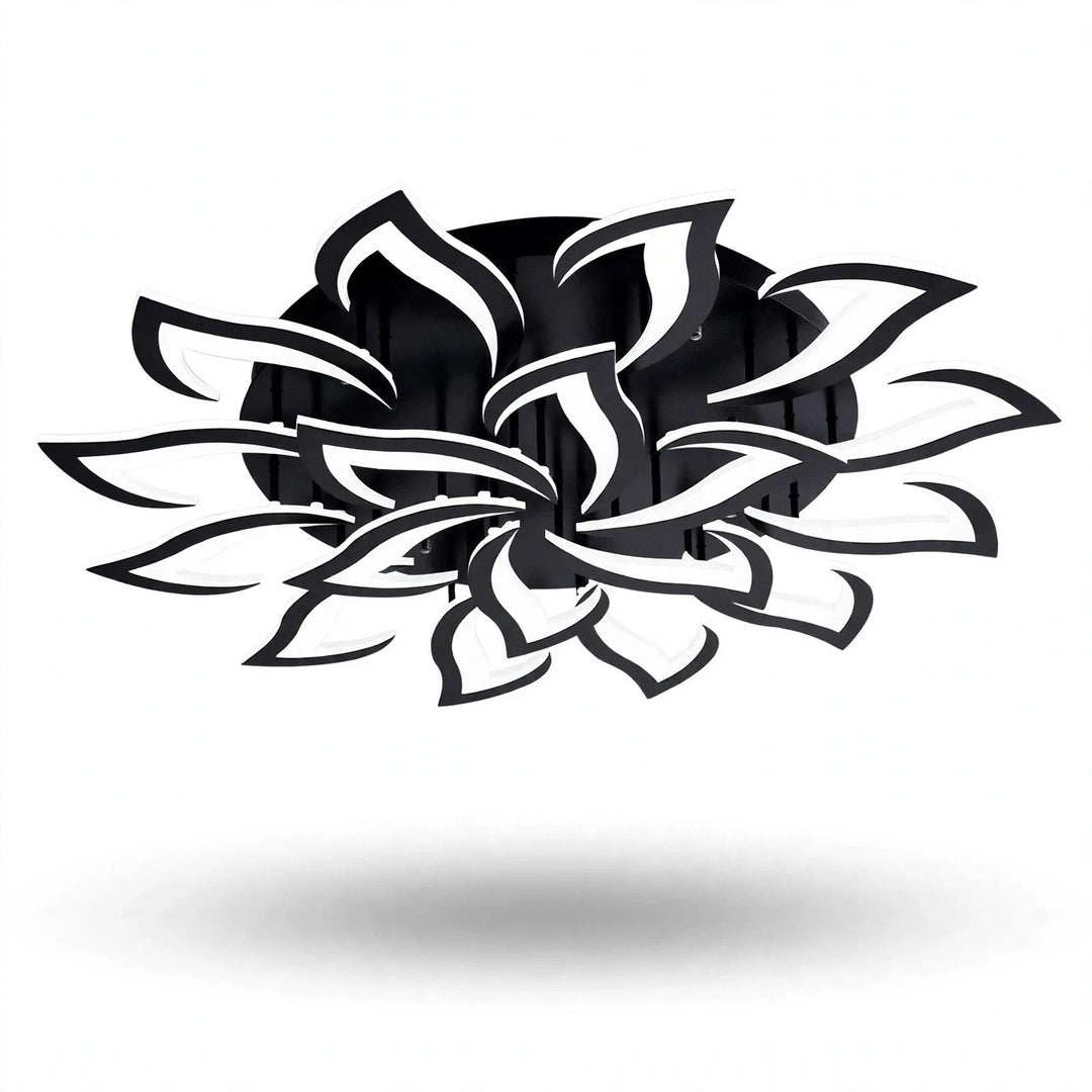 A black and white ceiling light has layered, outward-curving petals around a round black base against a plain white background.
